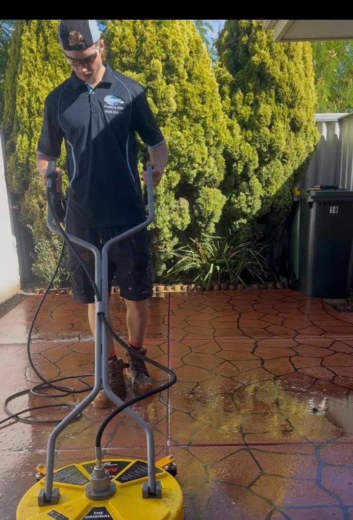 Flynn, Clearmark's owner, running a surface cleaner over stamped concrete